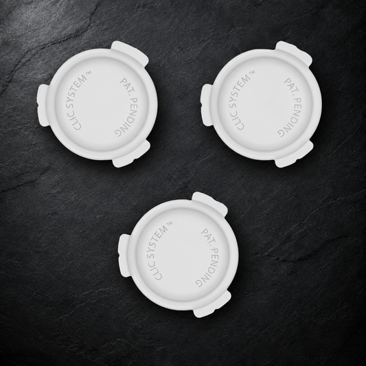 Three CliC eTAG base units on a dark slate surface